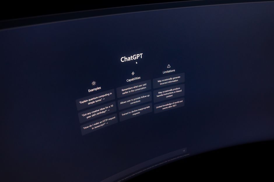 A curved computer screen displays the ChatGPT homepage with example prompts, capabilities, and limitations listed.